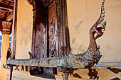 Vientiane, Laos - Wat Si Saket, the wooden trough in the shape of a Naga, used for the  ceremonial cleaning of Buddha statue.